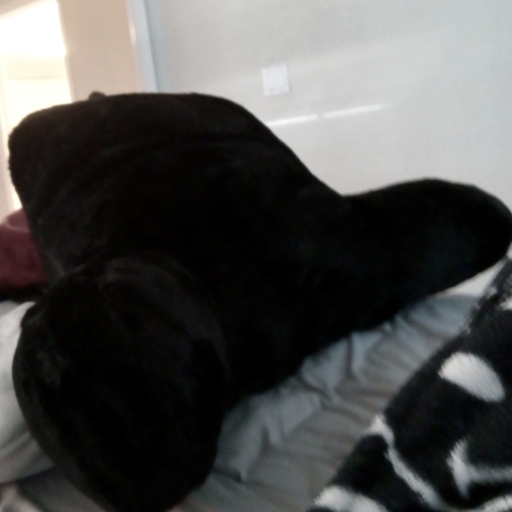black fluffy pillow with arms